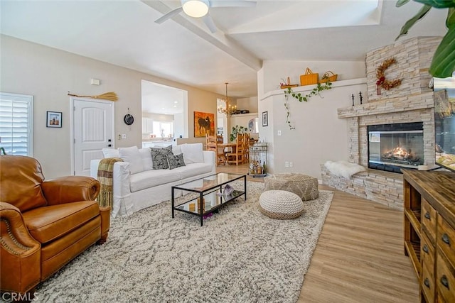 1001 Gibralter Rd, Landers, CA 92285 - living area with wood finished floors, a chandelier, a ceiling fan, and a stone fireplace