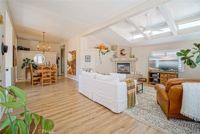 1001 Gibralter Rd, Landers, CA 92285 - living room with wood finished floors, a skylight, ceiling fan, a chandelier, and a large fireplace