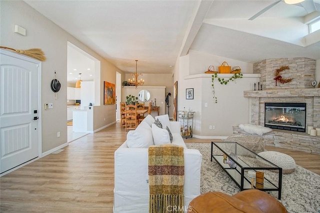 1001 Gibralter Rd, Landers, CA 92285 - living area with wood finished floors, a chandelier, ceiling fan, and a fireplace