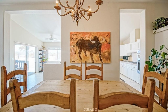 1001 Gibralter Rd, Landers, CA 92285 - dining space with lofted ceiling, a chandelier, and a ceiling fan