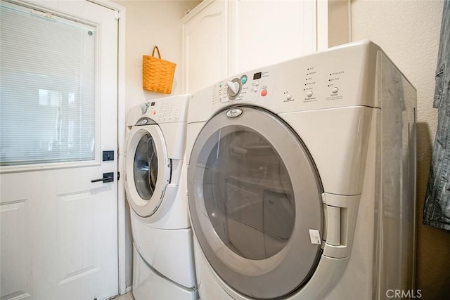 1001 Gibralter Rd, Landers, CA 92285 - washroom with washer and clothes dryer and cabinet space