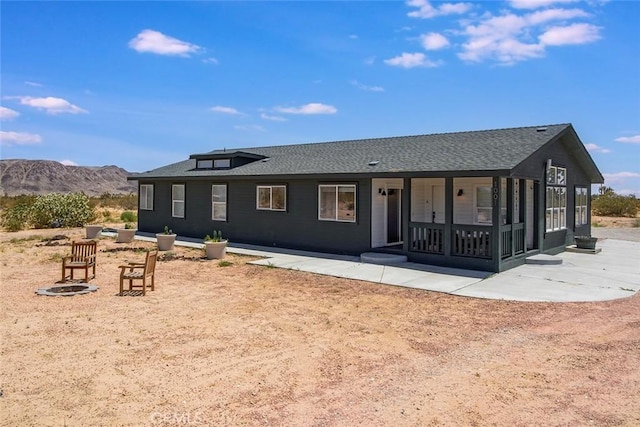 1001 Gibralter Rd, Landers, CA 92285 - rear view of property with a mountain view, roof with shingles, and a porch