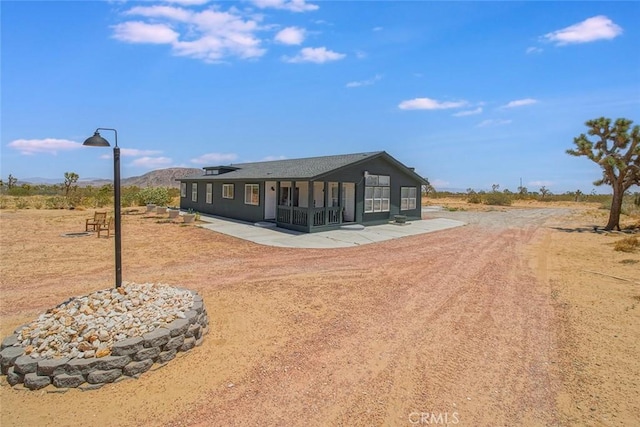 1001 Gibralter Rd, Landers, CA 92285 - rear view of property with dirt driveway and a patio area