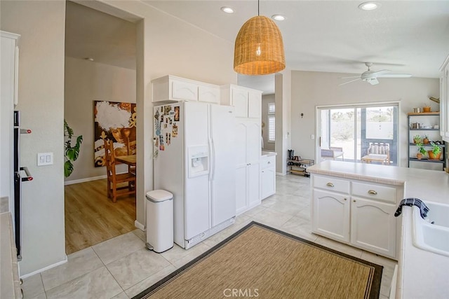 1001 Gibralter Rd, Landers, CA 92285 - kitchen with white refrigerator with ice dispenser, a ceiling fan, white cabinets, light countertops, and recessed lighting