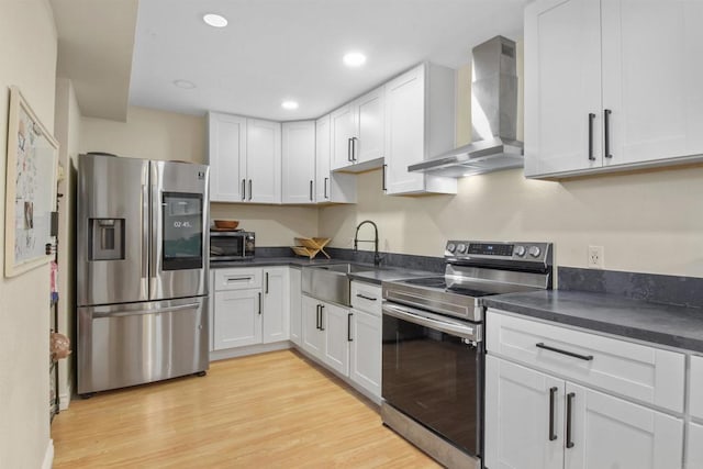 1450 Melrose Ave Unit 31, Chula Vista, CA 91911 - kitchen featuring stainless steel appliances, wall chimney range hood, dark countertops, light wood-type flooring, and recessed lighting