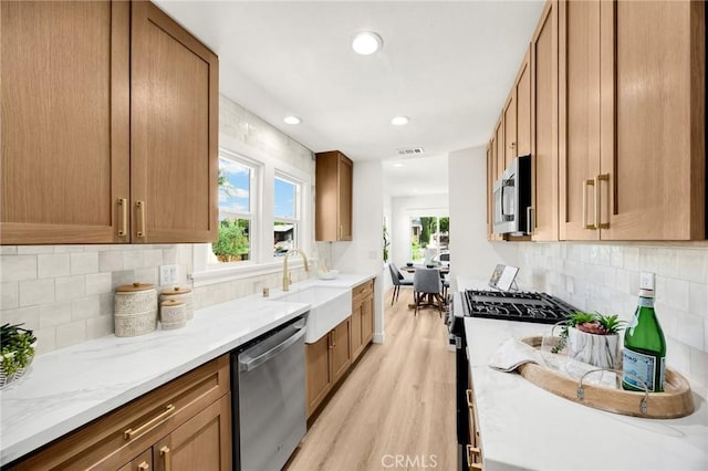 5336 Stratford Rd, Los Angeles, CA 90042 - kitchen featuring stainless steel appliances, light wood-style floors, light stone countertops, healthy amount of natural light, and recessed lighting