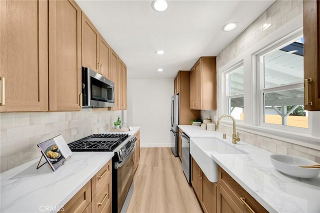 5336 Stratford Rd, Los Angeles, CA 90042 - kitchen featuring stainless steel appliances, backsplash, light wood-style floors, light stone countertops, and recessed lighting