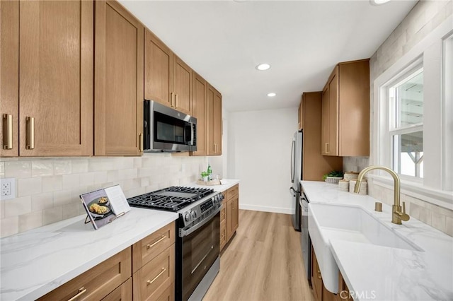 5336 Stratford Rd, Los Angeles, CA 90042 - kitchen with appliances with stainless steel finishes, backsplash, brown cabinets, light wood-style floors, and recessed lighting
