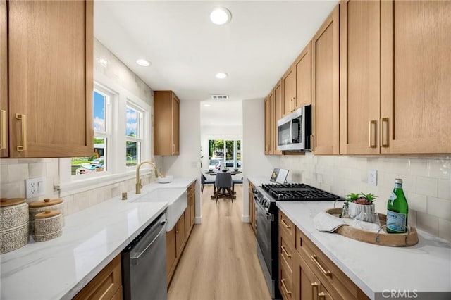 5336 Stratford Rd, Los Angeles, CA 90042 - kitchen with appliances with stainless steel finishes, light wood finished floors, light stone countertops, recessed lighting, and decorative backsplash
