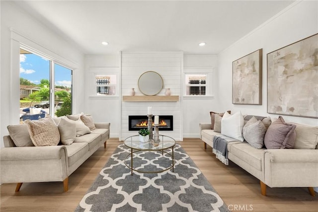 5336 Stratford Rd, Los Angeles, CA 90042 - living area featuring a large fireplace, wood finished floors, recessed lighting, and ornamental molding