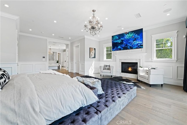 17528 Jayden Ln, Encino, CA 91316 - bedroom featuring a decorative wall, a premium fireplace, recessed lighting, light wood finished floors, and wainscoting