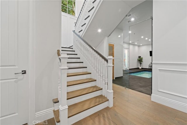 17528 Jayden Ln, Encino, CA 91316 - stairs featuring wood finished floors and recessed lighting