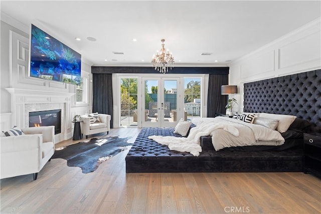 17528 Jayden Ln, Encino, CA 91316 - bedroom featuring access to exterior, crown molding, a chandelier, wood finished floors, and french doors