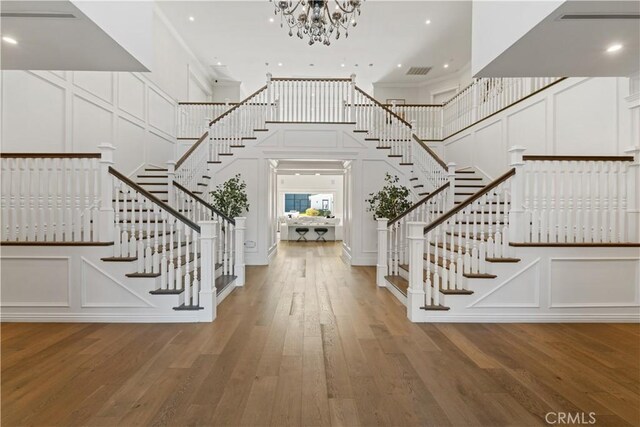 17528 Jayden Ln, Encino, CA 91316 - foyer entrance with a decorative wall, stairway, a high ceiling, a chandelier, and wood finished floors