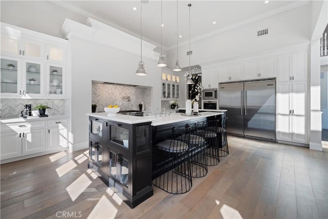 17528 Jayden Ln, Encino, CA 91316 - kitchen with built in appliances, white cabinetry, decorative backsplash, light countertops, and pendant lighting