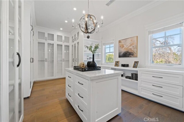 17528 Jayden Ln, Encino, CA 91316 - spacious closet with a chandelier and dark wood-style flooring