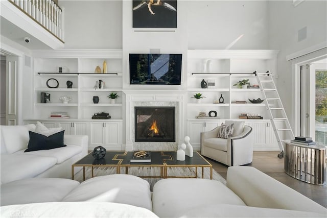 17528 Jayden Ln, Encino, CA 91316 - living area with a fireplace, wood finished floors, built in shelves, and a high ceiling