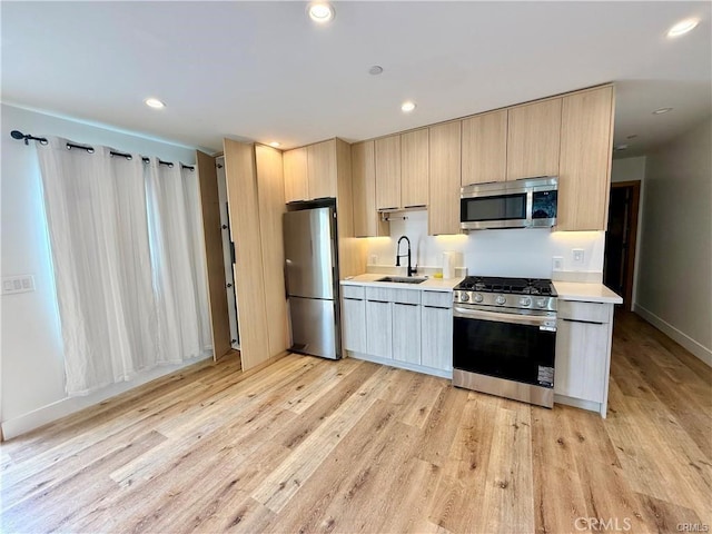 6904 Corbin Ave, Reseda, CA 91335 - kitchen with appliances with stainless steel finishes, light brown cabinetry, light countertops, light wood finished floors, and modern cabinets