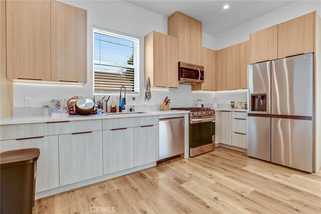 6904 Corbin Ave, Reseda, CA 91335 - kitchen featuring stainless steel appliances, light countertops, modern cabinets, light brown cabinets, and recessed lighting