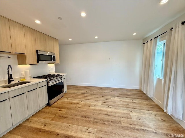 6904 Corbin Ave, Reseda, CA 91335 - kitchen with stainless steel appliances, light wood-type flooring, light countertops, light brown cabinets, and recessed lighting