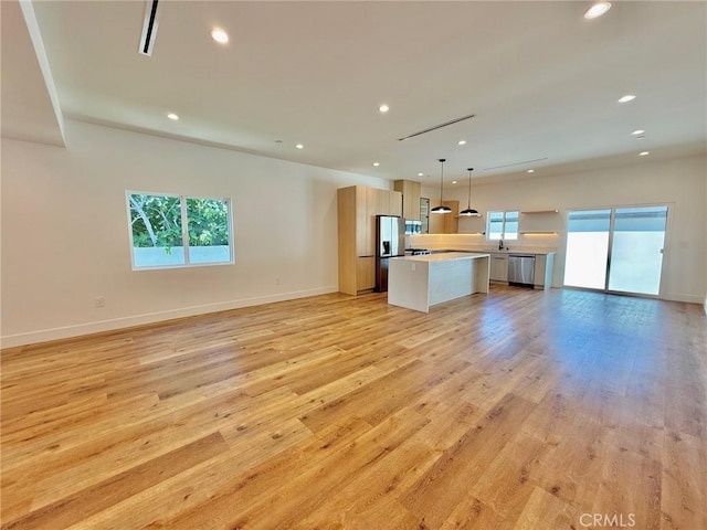 6904 Corbin Ave, Reseda, CA 91335 - unfurnished living room with healthy amount of natural light, recessed lighting, and light wood-style floors