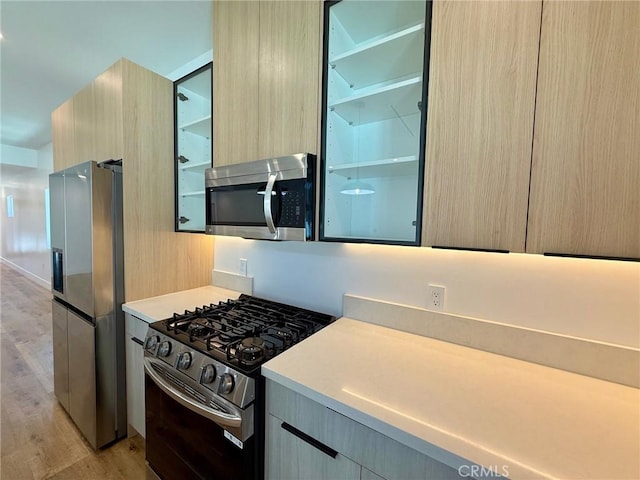 6904 Corbin Ave, Reseda, CA 91335 - kitchen featuring appliances with stainless steel finishes, light wood-type flooring, modern cabinets, and light countertops