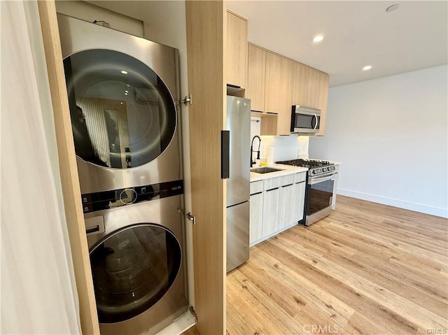 6904 Corbin Ave, Reseda, CA 91335 - laundry area featuring stacked washer / dryer, light wood-style flooring, and recessed lighting