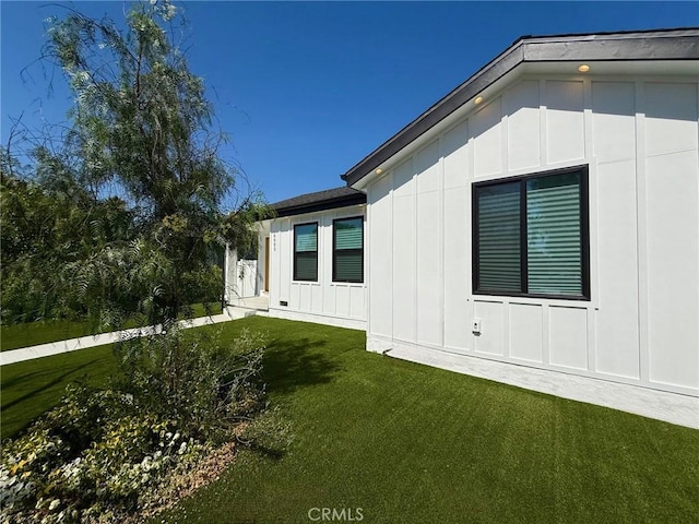 6904 Corbin Ave, Reseda, CA 91335 - view of side of home featuring board and batten siding and a yard