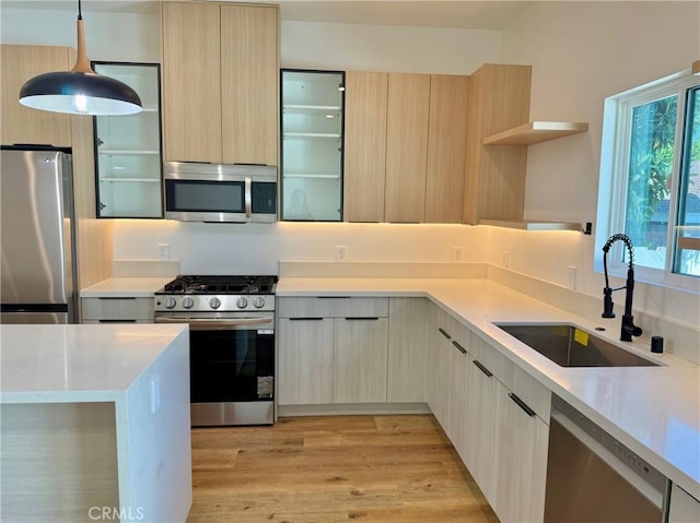6904 Corbin Ave, Reseda, CA 91335 - kitchen with appliances with stainless steel finishes, open shelves, modern cabinets, light brown cabinetry, and light countertops