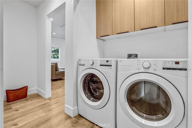 6904 Corbin Ave, Reseda, CA 91335 - washroom with cabinet space, separate washer and dryer, and light wood finished floors
