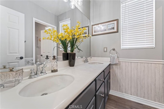 28549 Oakhurst Way, Temecula, CA 92591 - bathroom featuring double vanity, wood finished floors, and a wainscoted wall