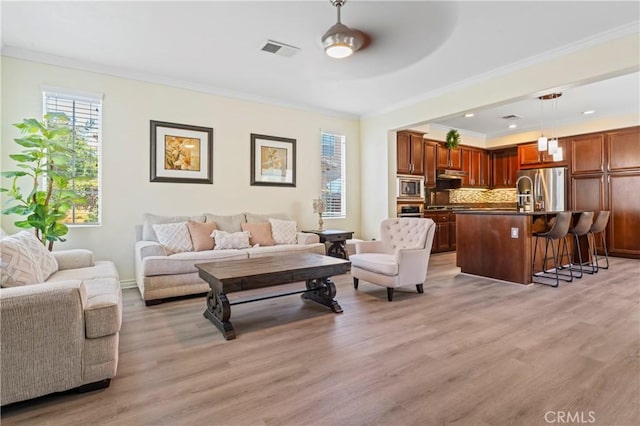 28549 Oakhurst Way, Temecula, CA 92591 - living area with light wood-style floors, crown molding, and a ceiling fan