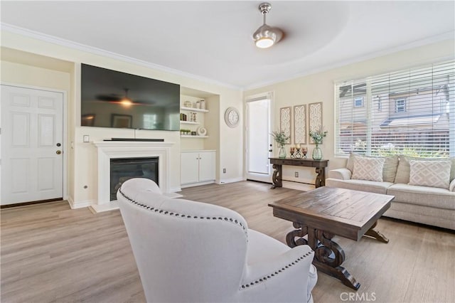 28549 Oakhurst Way, Temecula, CA 92591 - living room featuring wood finished floors, ornamental molding, a glass covered fireplace, and built in features