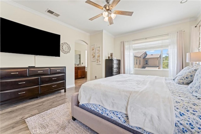 28549 Oakhurst Way, Temecula, CA 92591 - bedroom with ornamental molding, light wood-type flooring, arched walkways, a ceiling fan, and connected bathroom