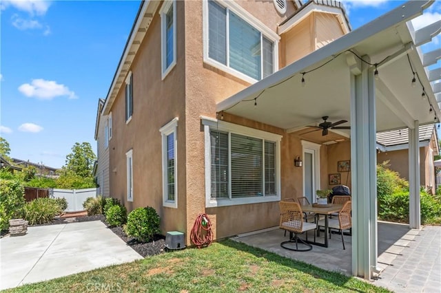 28549 Oakhurst Way, Temecula, CA 92591 - rear view of house featuring stucco siding, a patio area, and a ceiling fan