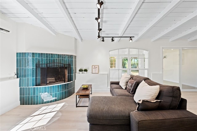 647 Magnolia Ave, Brea, CA 92821 - living room with track lighting, wood finished floors, beam ceiling, and a tiled fireplace