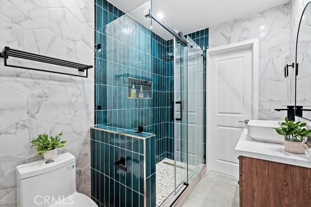647 Magnolia Ave, Brea, CA 92821 - full bathroom featuring tile walls, vanity, and a stall shower