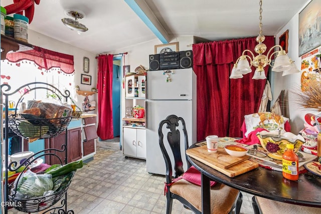 1156 S Alma Ave, Los Angeles, CA 90023 - kitchen featuring freestanding refrigerator, a chandelier, and tile patterned floors