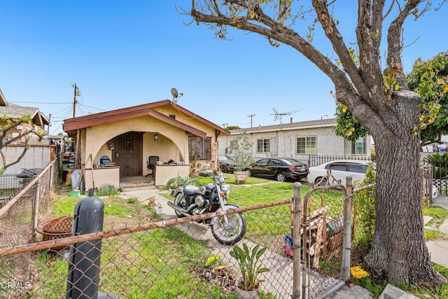 1156 S Alma Ave, Los Angeles, CA 90023 - rear view of property featuring stucco siding and a gate