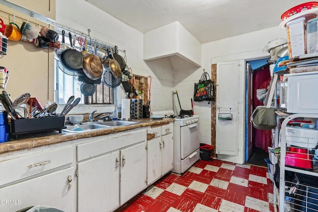 1156 S Alma Ave, Los Angeles, CA 90023 - kitchen featuring white range with gas cooktop, light flooring, and white cabinets