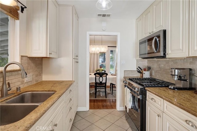 20108 Wayne Ave, Torrance, CA 90503 - kitchen with appliances with stainless steel finishes, light tile patterned floors, light stone countertops, and tasteful backsplash