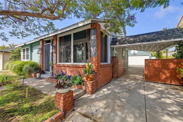 20108 Wayne Ave, Torrance, CA 90503 - view of front facade with an attached carport, brick siding, concrete driveway, and an outdoor structure