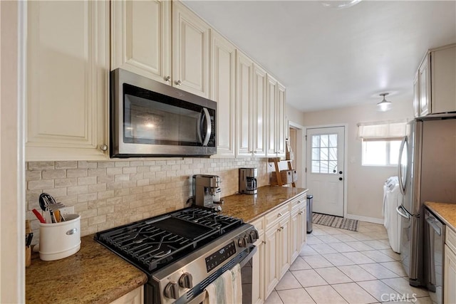 20108 Wayne Ave, Torrance, CA 90503 - kitchen with stainless steel appliances, washing machine and dryer, cream cabinets, tasteful backsplash, and light tile patterned flooring