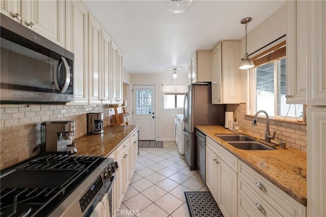 20108 Wayne Ave, Torrance, CA 90503 - kitchen with stainless steel appliances, separate washer and dryer, tasteful backsplash, hanging light fixtures, and light tile patterned floors