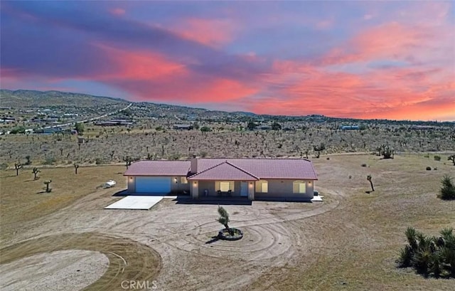25625 Rancho St, Apple Valley, CA 92308 - ranch-style house featuring driveway, a garage, a tile roof, and a view of rural / pastoral area