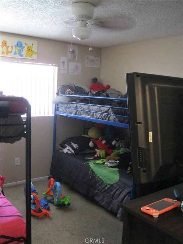 235 E 7th St, San Jacinto, CA 92583 - carpeted bedroom featuring a textured ceiling and a ceiling fan