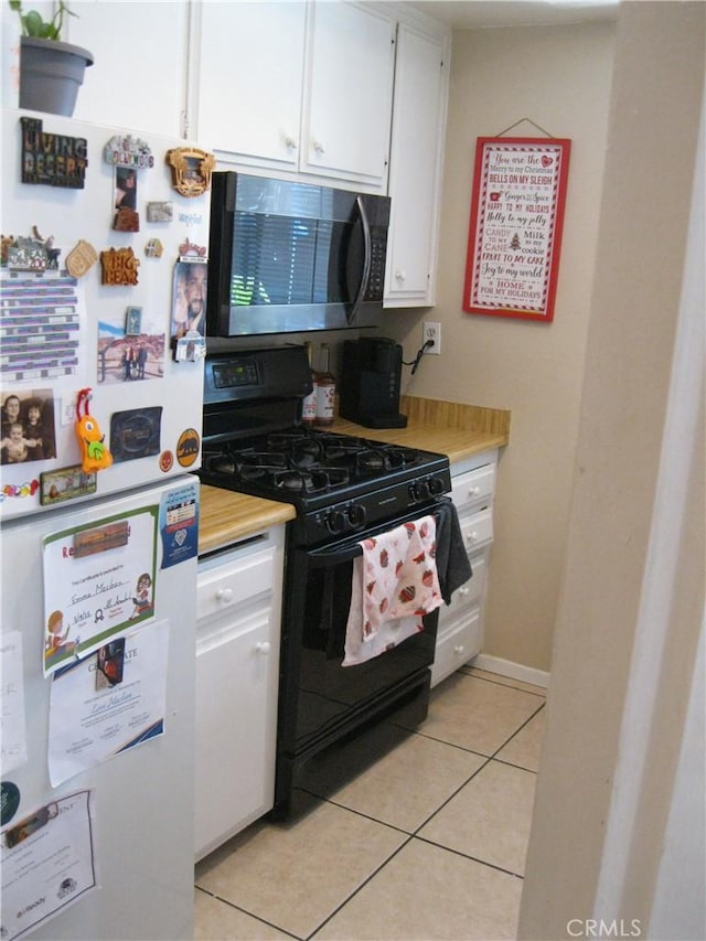 235 E 7th St, San Jacinto, CA 92583 - kitchen with freestanding refrigerator, black gas stove, stainless steel microwave, and light countertops