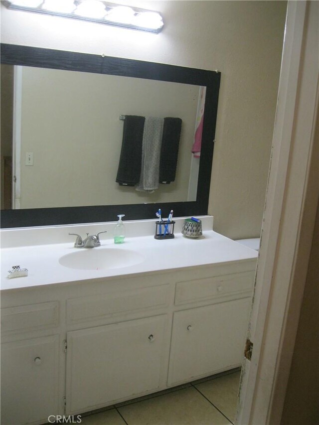 235 E 7th St, San Jacinto, CA 92583 - bathroom with vanity and tile patterned flooring