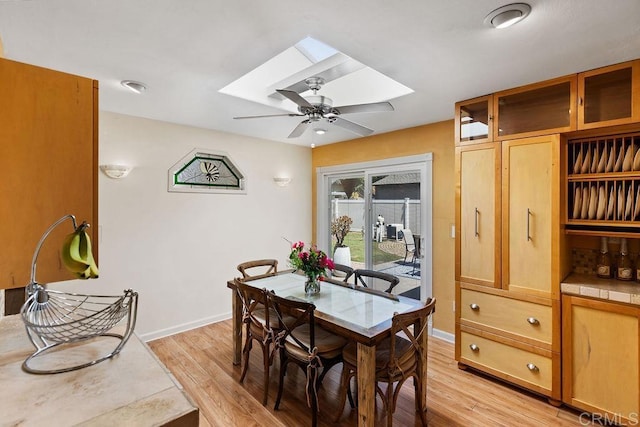 10048 Waynecrest Ln, Santee, CA 92071 - dining room featuring a skylight, a ceiling fan, and light wood-type flooring