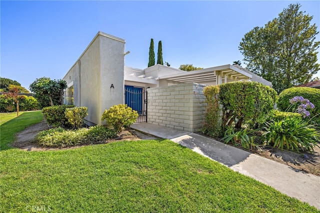 2133 Via Puerta Unit A, Laguna Woods, CA 92637 - view of front of house with stucco siding and a gate